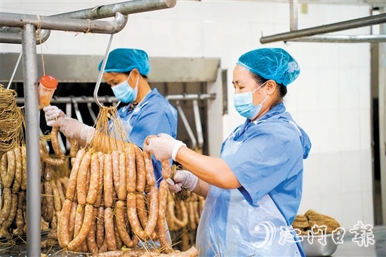 工人們正在制作禮樂臘味。邱昱