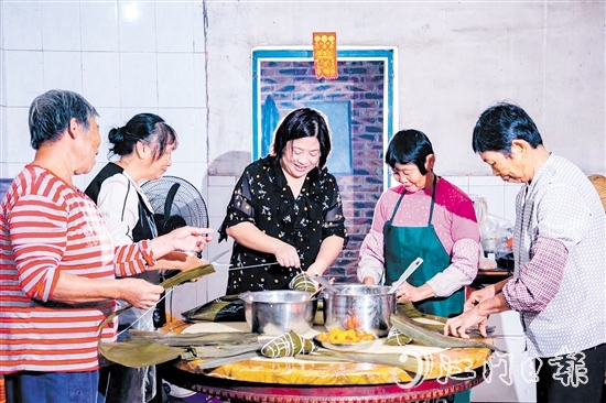 非遺傳承人呂艷卿正在傳授柴火粽的制作技藝。