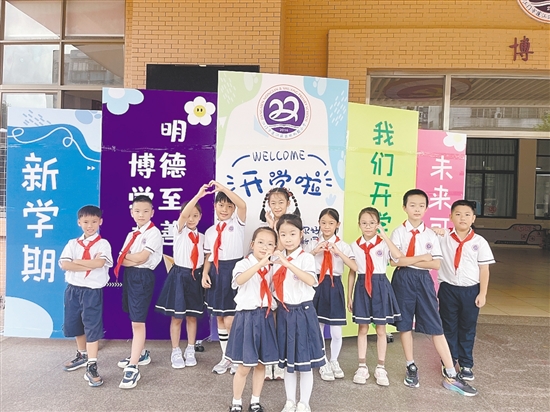 開學首日，農林雙朗小學的學生們在學校精心準備的背景板前留影。